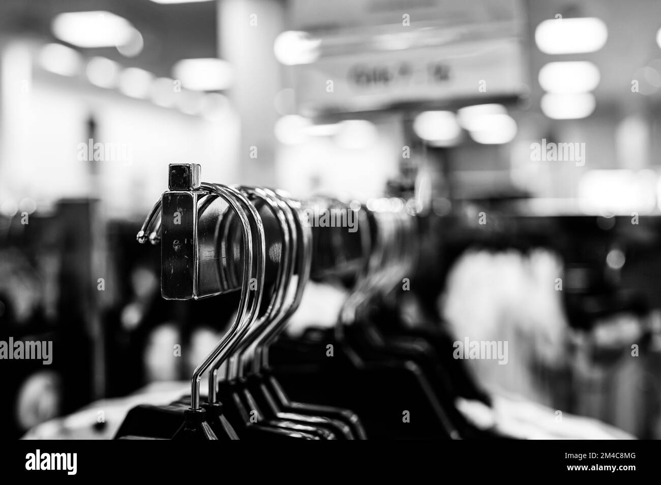 Row of coat hangers on a retail store shelf Stock Photo Alamy