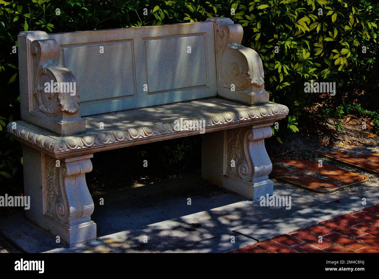 A solitary stone bench in the park at Cranes Roost, Altamonte Springs, Florida Stock Photo