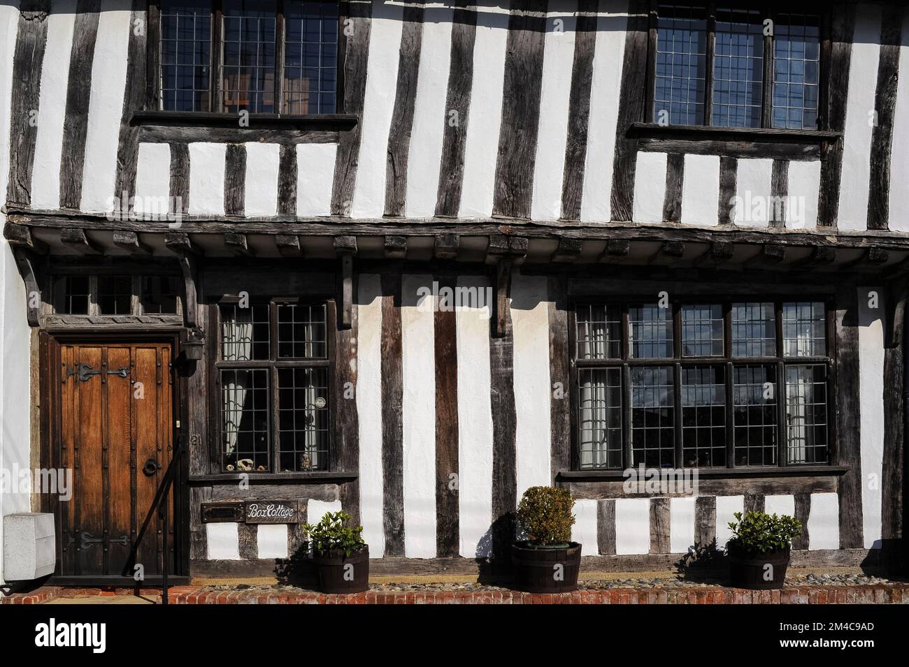 Leaning to the right jettied half timbered upper storey of box cottage