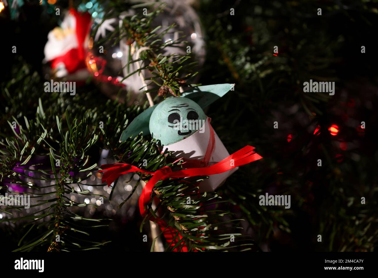 A Star Wars Baby Yoda, or Grogu, Christmas decoration pictured on a Christmas Tree in Chichester, West Sussex, UK. Stock Photo