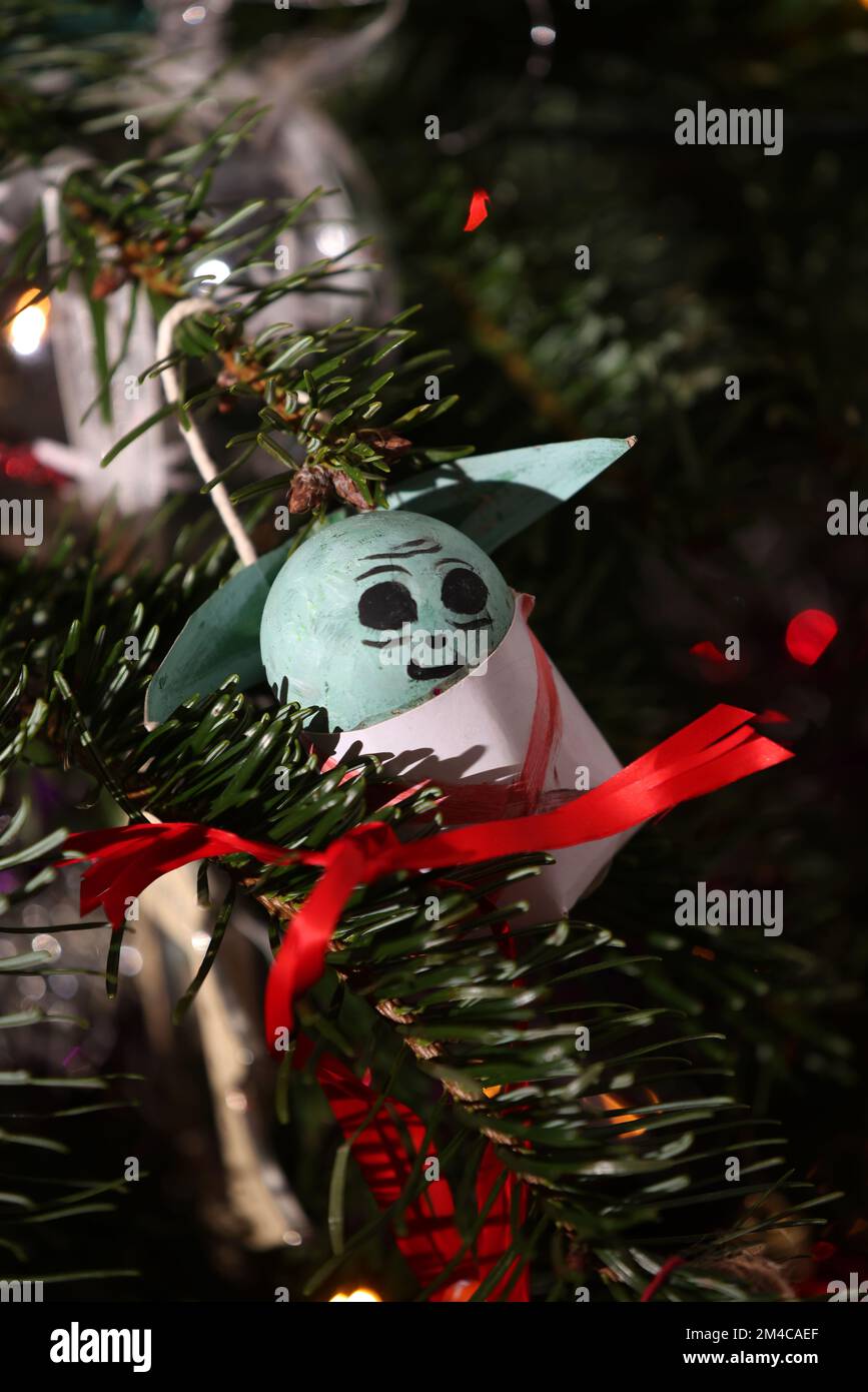 A Star Wars Baby Yoda, or Grogu, Christmas decoration pictured on a Christmas Tree in Chichester, West Sussex, UK. Stock Photo