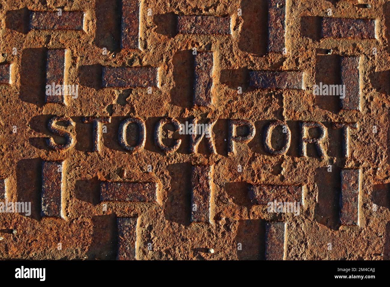 Stockport rusty cast iron grid, in evening sun Stock Photo