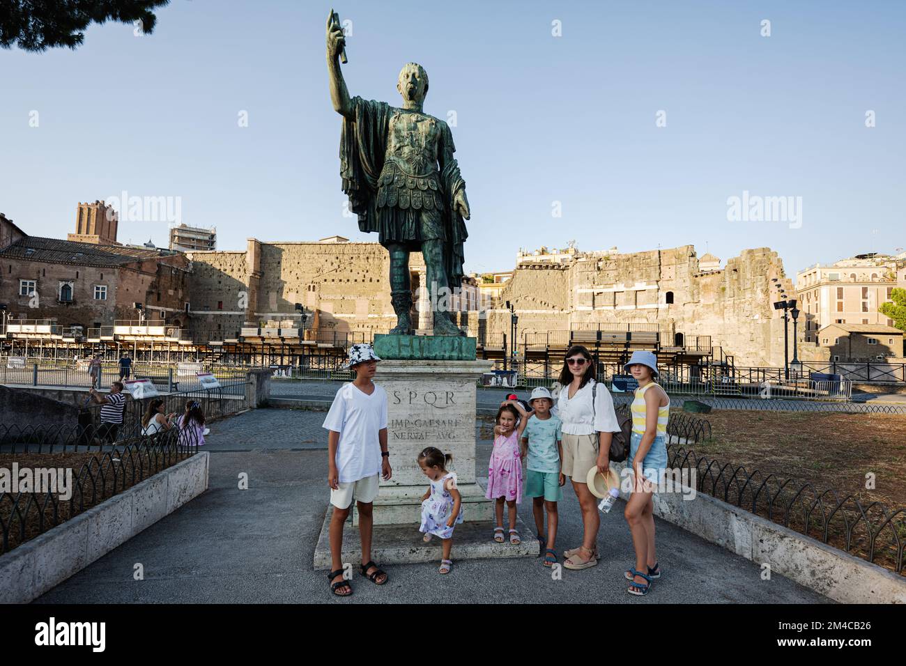 Rome, Italy - July 27, 2022: Marco Cocceio Nerva Cesare Augusto statue. Family posed near Statua di Nerva. Stock Photo
