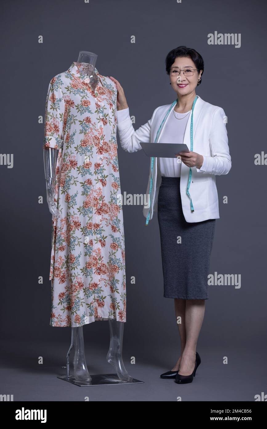Elegant Chinese fashion designer working Stock Photo - Alamy