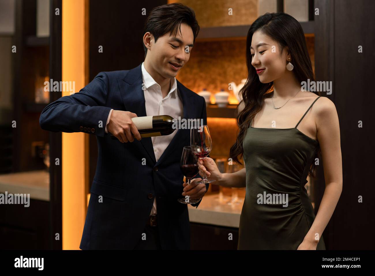 Young Chinese couple drinking red wine Stock Photo - Alamy