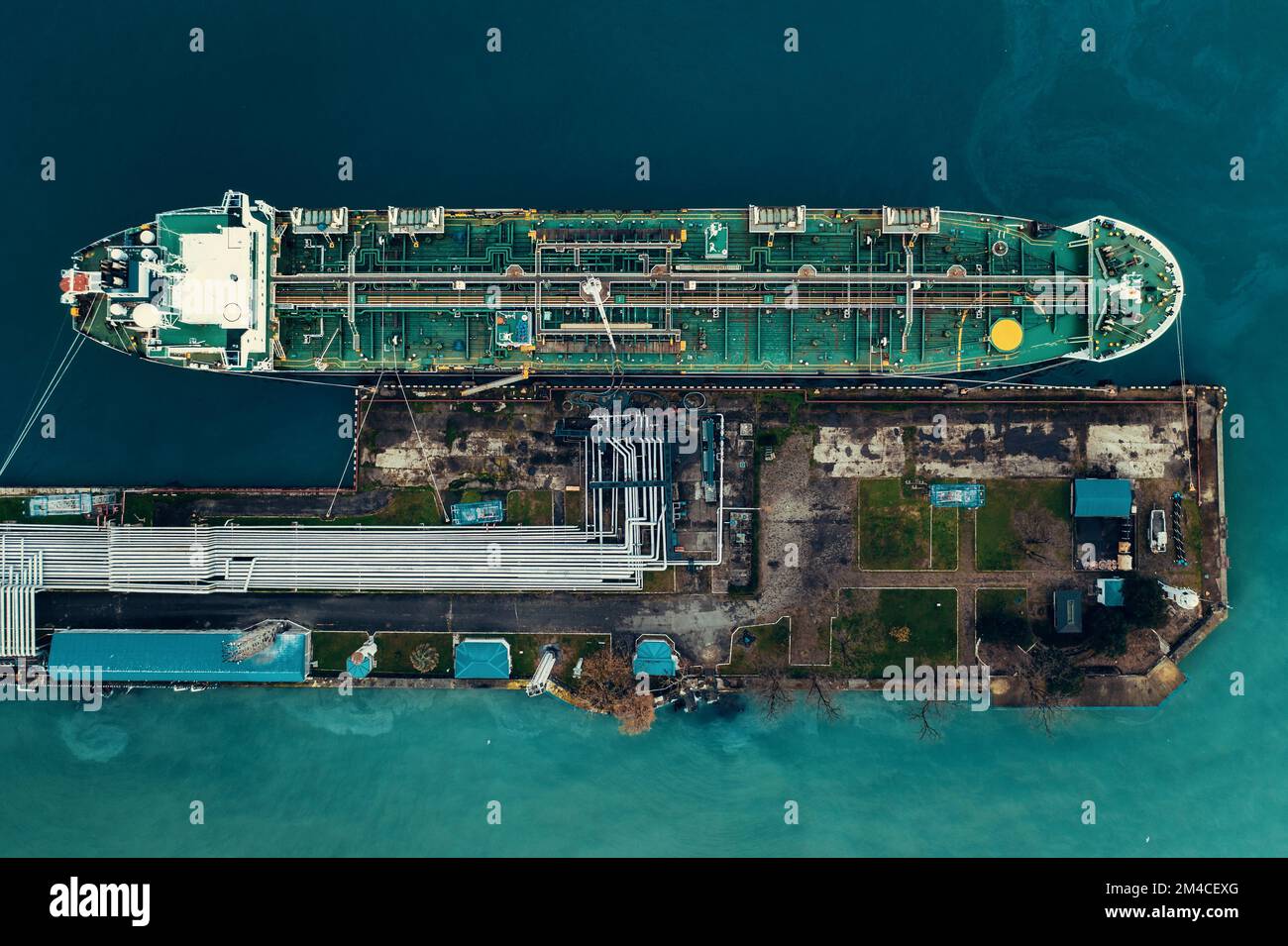 Oil tanker ship in industrial port aerial top view, logistic and transportation oil and gas industry. Stock Photo