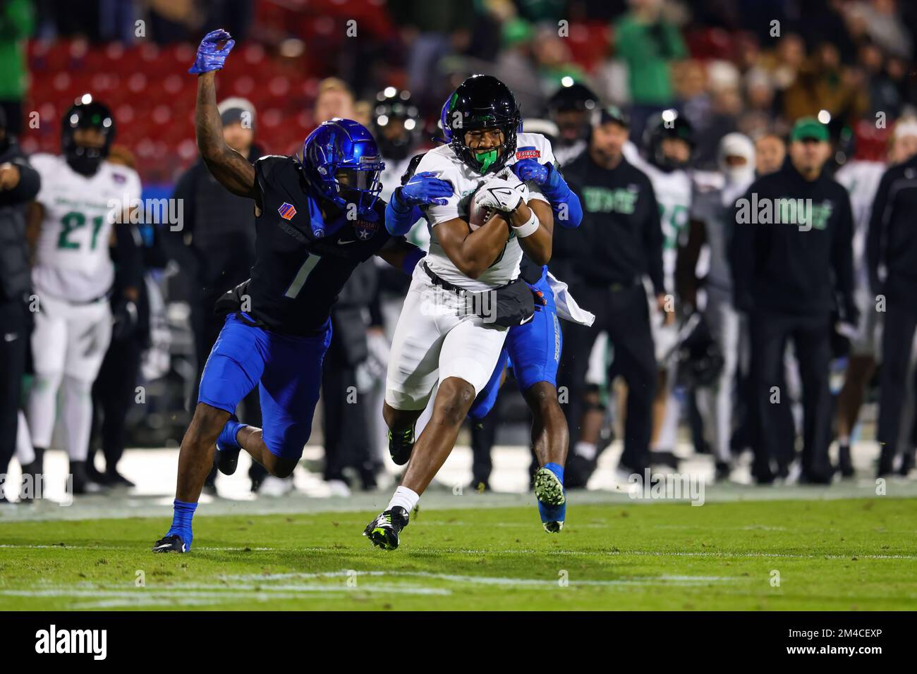 North Texas Mean Green wide receiver Damon Ward Jr. (8) is brought down by Boise State Broncos cornerback Caleb Biggers (1) and safety Seyi Oladipo (2 Stock Photo
