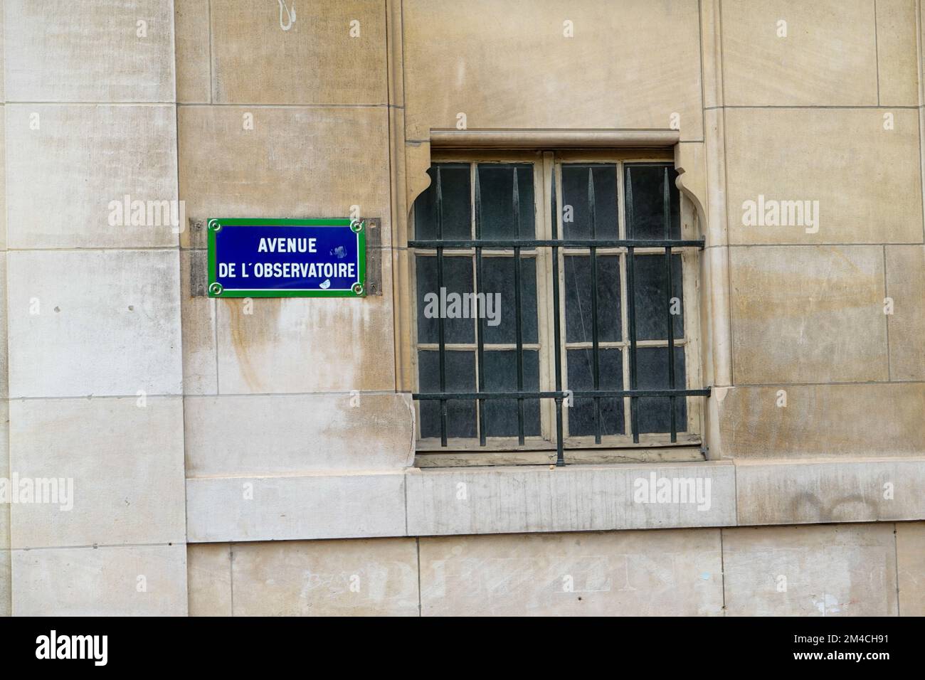Street sign and barred window on building wall, Avenue de l’Observatoire, Paris, France. Stock Photo