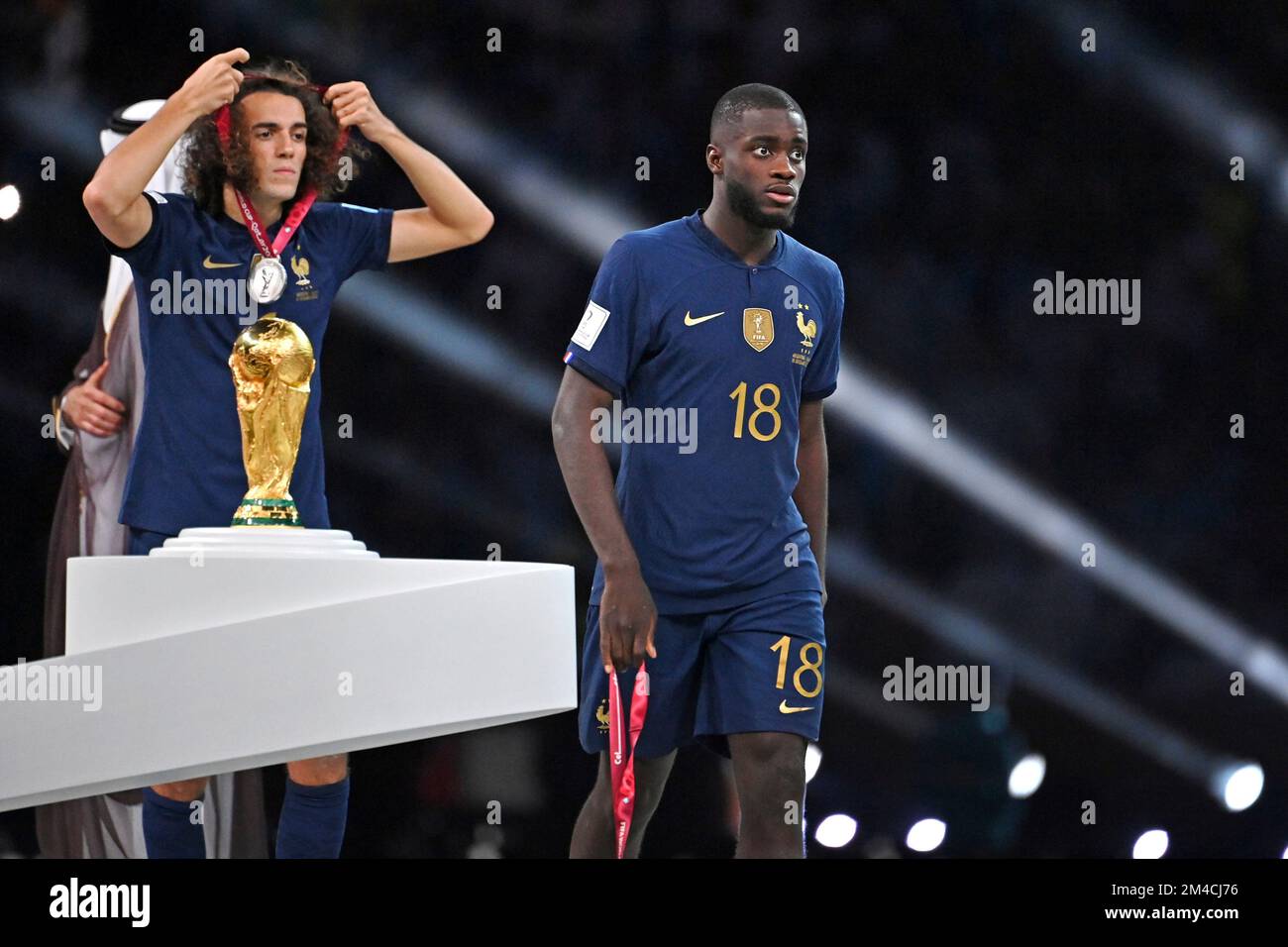 Award ceremony: UPAMECANO Dayot (FRA) walks past the trophy, cup, trophy,  disappointment, frustrated, disappointed, frustrated, rejected, left:  GUENDOUZI Matteo (FRA). Game 64, FINAL Argentina - France 4-2 nE (3-3) on  December 18th