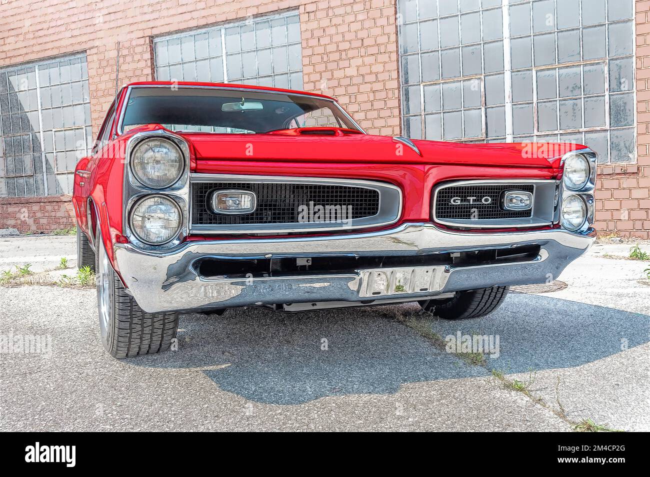 Maryville, Tennessee, United States - May 12, 2011: Beautiful like-new red 1966 Pontiac GTO photographed from the right front of the car with wide-ang Stock Photo