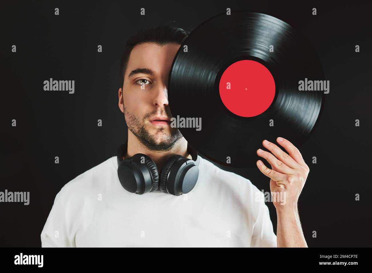 man-holding-retro-vinyl-record-covering-face-vintage-music-style-male