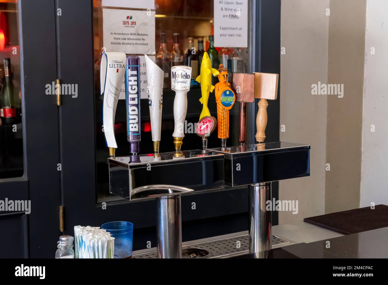 Fancy decorative draft beer tap handles at an outdoor bar in Montgomery