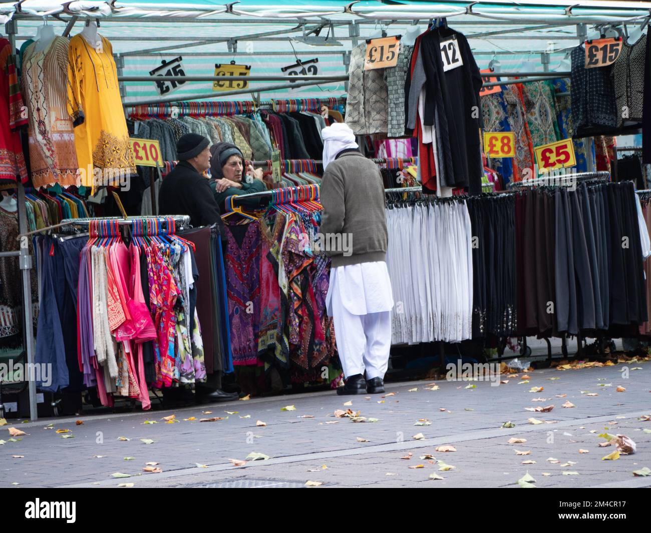 Walthamstow market, London, UK, the longest outdoor market in Europe, with traders and market stall holders serving shoppers, with prices displayed in pounds Stock Photo