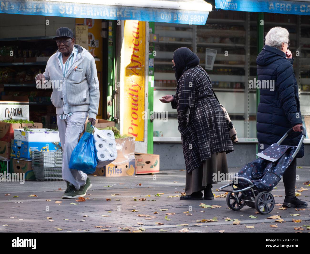 A homeless beggar, begging for cash in Walthamstow market, London, UK, the longest outdoor market in Europe, Stock Photo