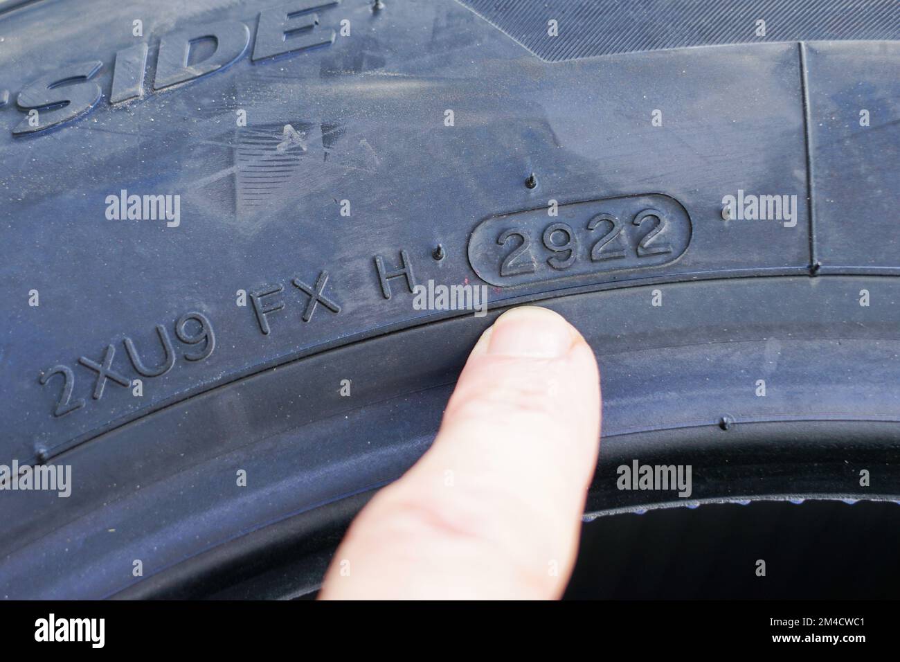 Side view of new tire with designation of week and year of tire