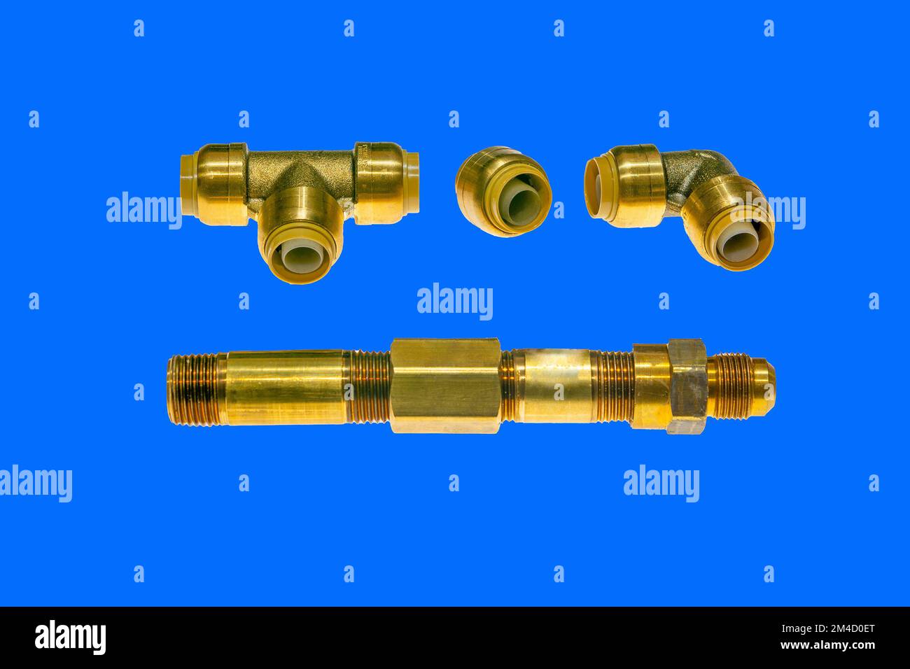 Brass plumbing parts, pipes, elbows, corners and plugs on a white
