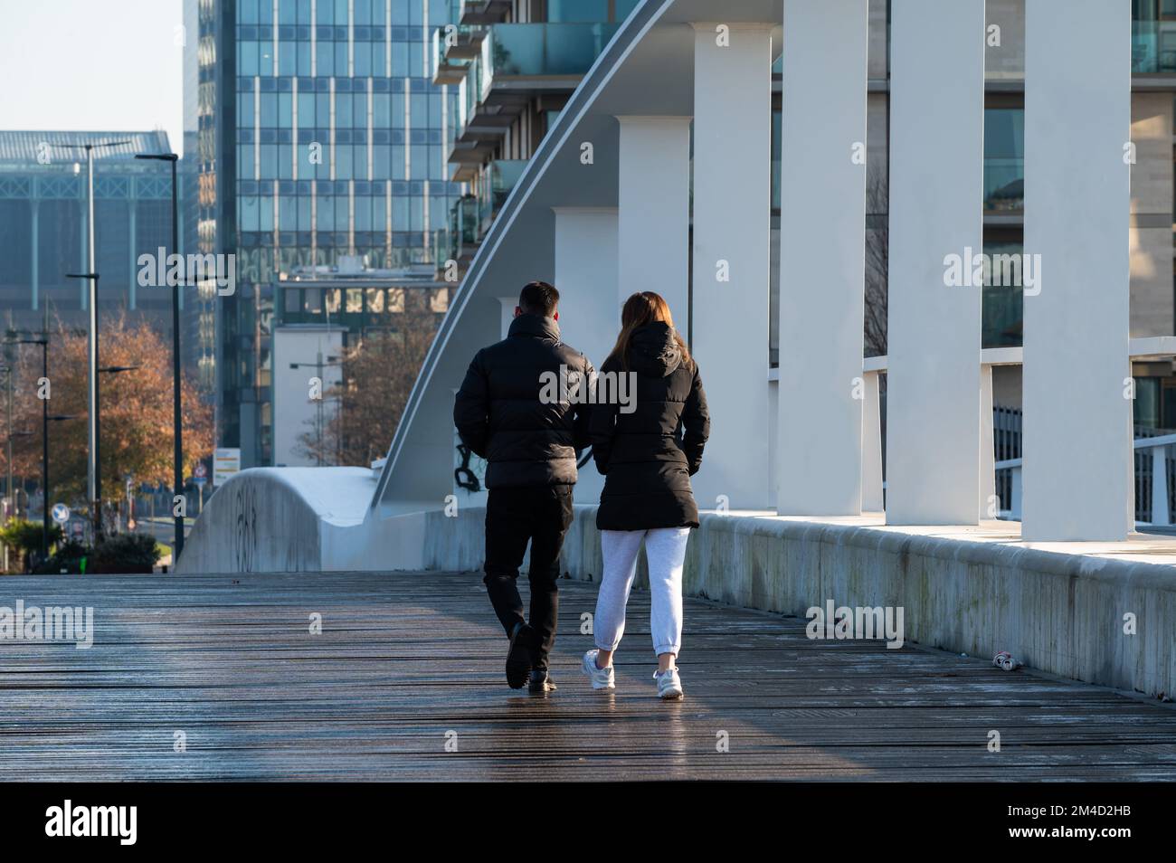 Molenbeek, Brussels Capital Region, Belgium - 12 17 2022 - Young couple walking at the new Suzan Daniel bridge with a wooden pedestrian passway Stock Photo