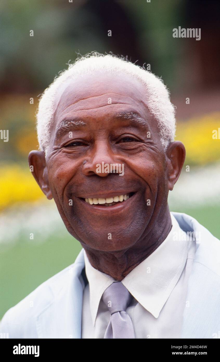 Older African-American man headshot with grey hair smiling at the camera Stock Photo