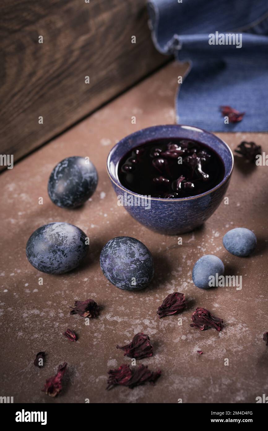 Process of dyeing eggs with natural paints for Easter. Stock Photo