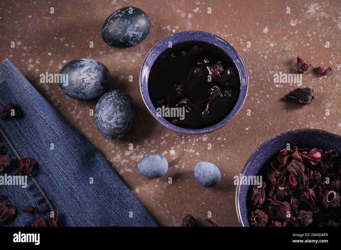 Process of dyeing eggs with natural paints for Easter. Stock Photo