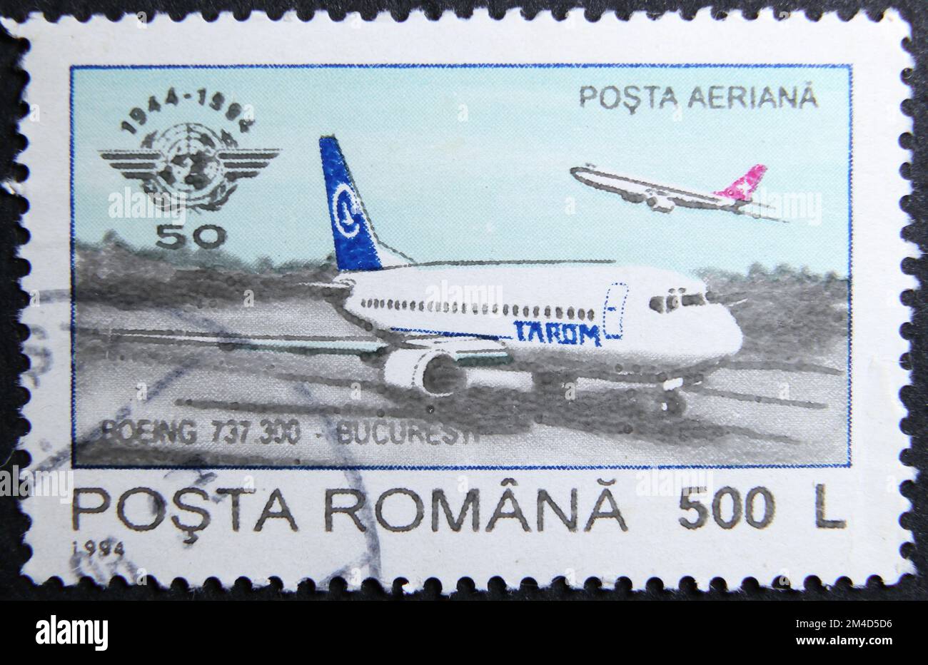 ISTANBUL, TURKEY - JANUARY 24, 2021: Romanian stamp shows ICAO, 50th anniversary, Tarom Boeing 737-300 circa 1994 Stock Photo