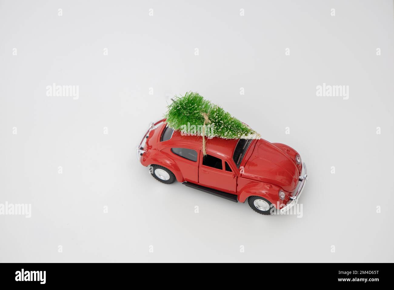 Vintage red car decor with Christmas Tree. Transporting Christmas tree