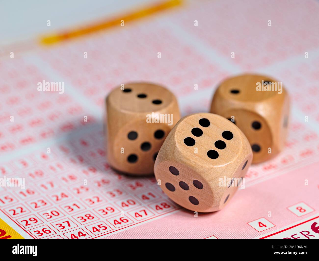 Wooden dice on a lottery ticket Stock Photo - Alamy