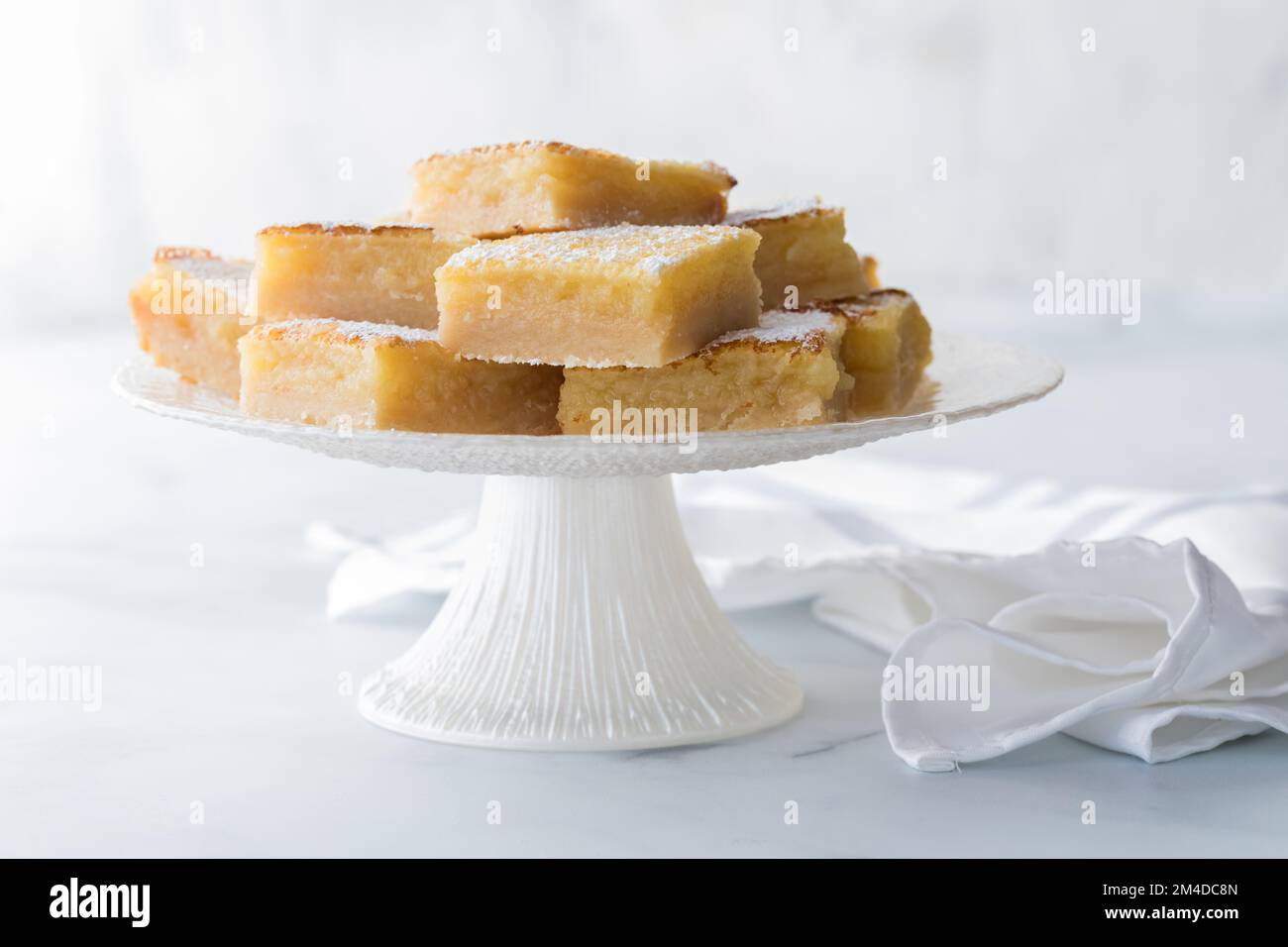Sweet and tangy lemon bars on a white pedestal stand Stock Photo Alamy