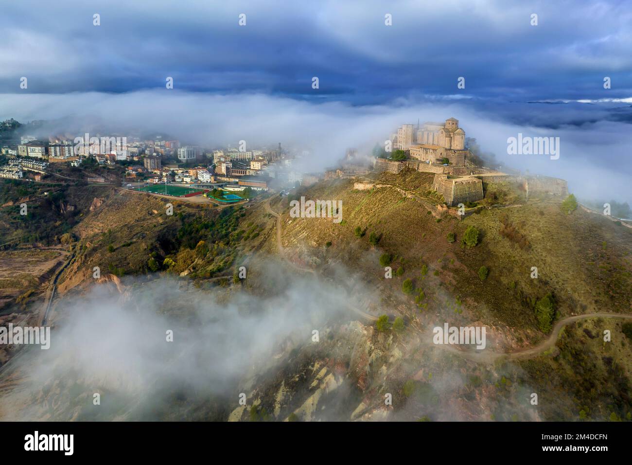 Cardona castle is a famous medieval castle in Catalonia. Between very dense fog that hides the city Stock Photo