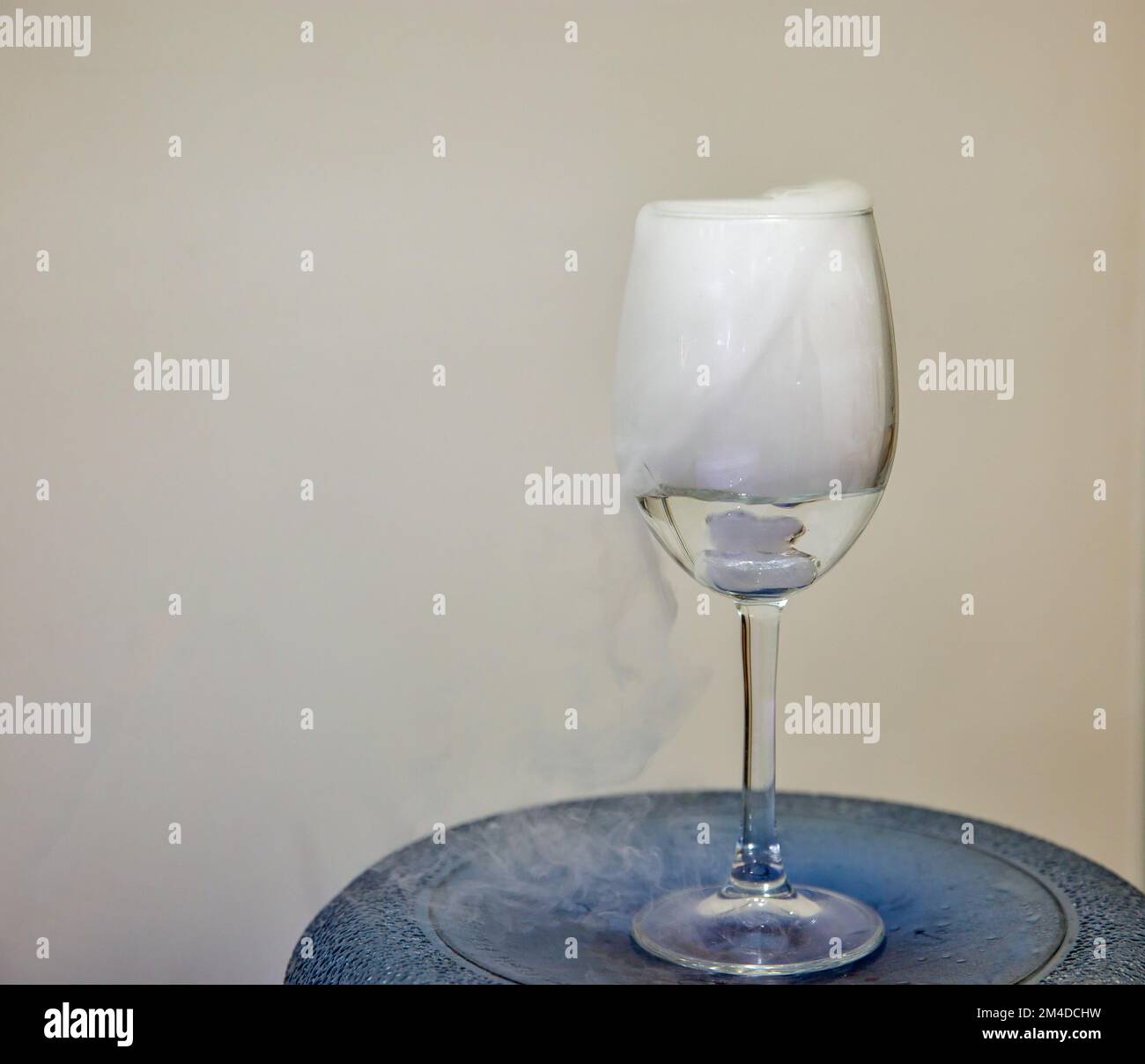 Closeup glass with white fog closeup. Chemical reaction of dry ice with