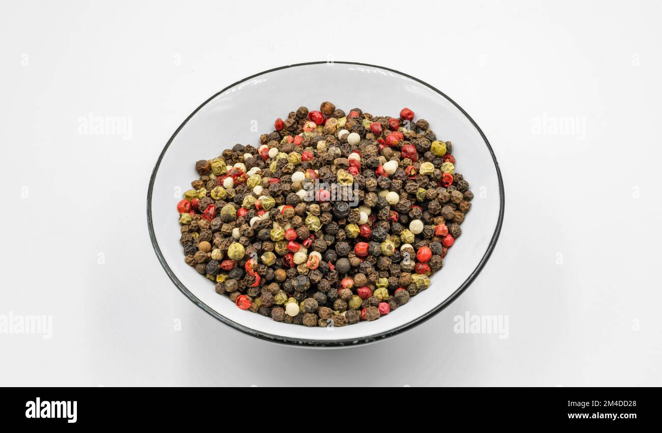 A mixture of peppers in a bowl closeup on white background Stock Photo