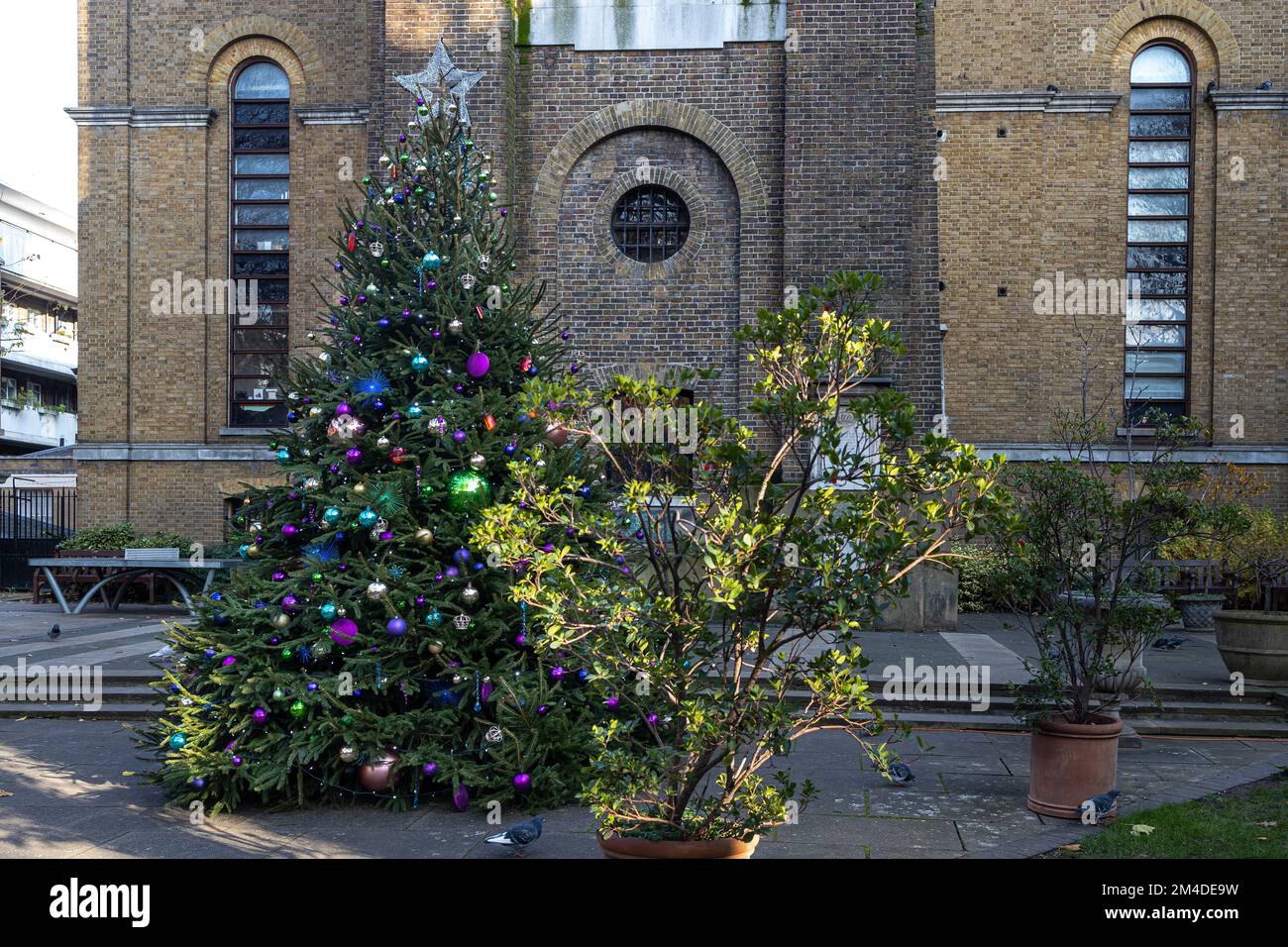 Christmas tree decorated in the courtyard of a medieval church Stock