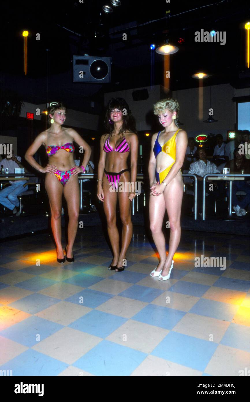 Three bikini beauty contestants in a local neighborhood bar. Circa 1987 Stock Photo