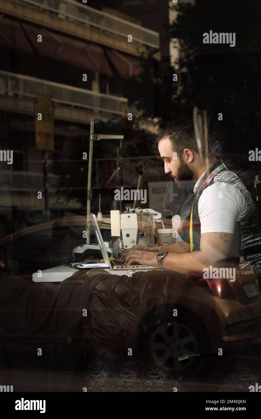 Man sewing Stock Photo