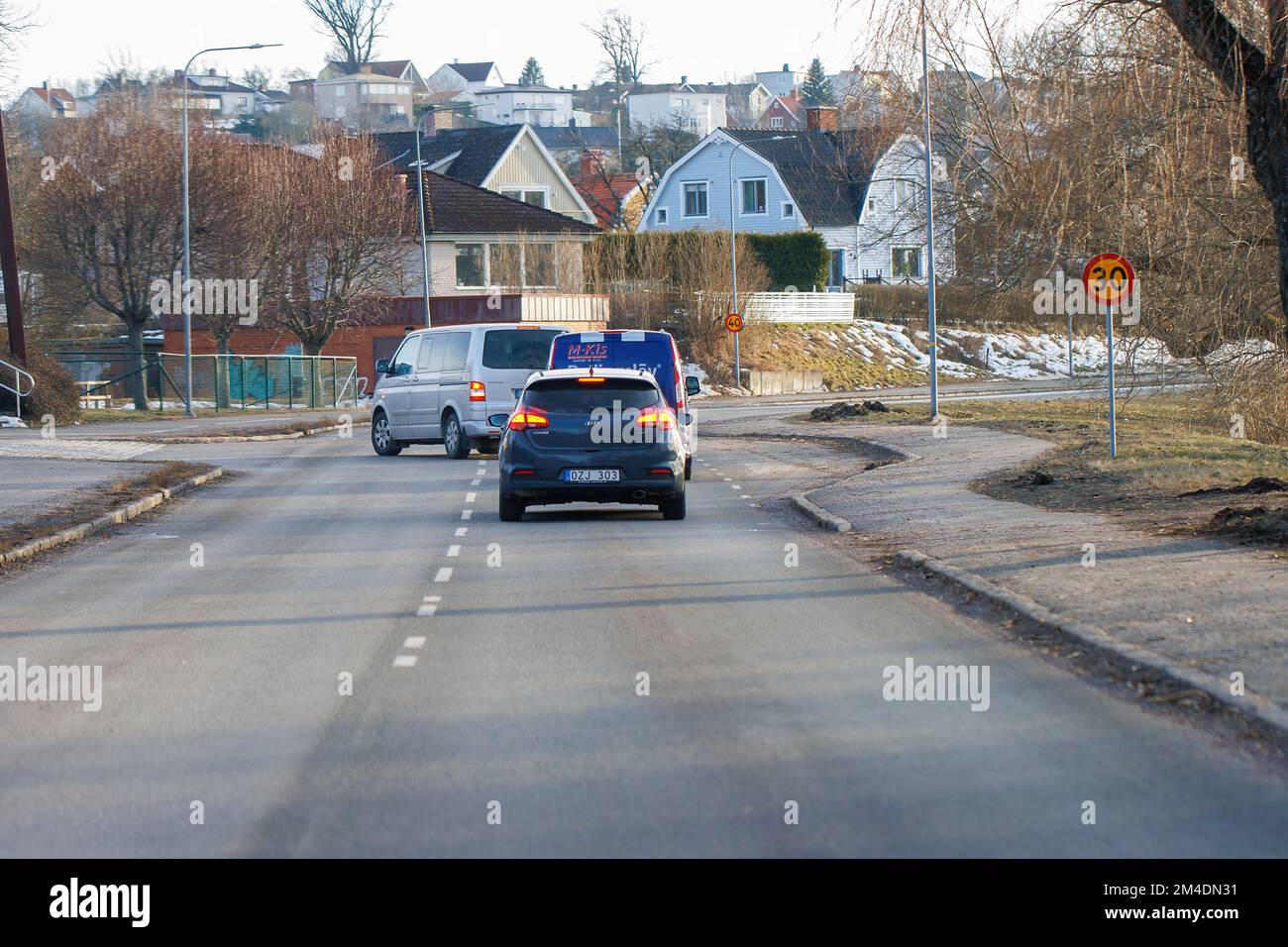 Motala Sweden March  2022 Cars in traffic, mini van making a left turn, cars are breaking Stock Photo