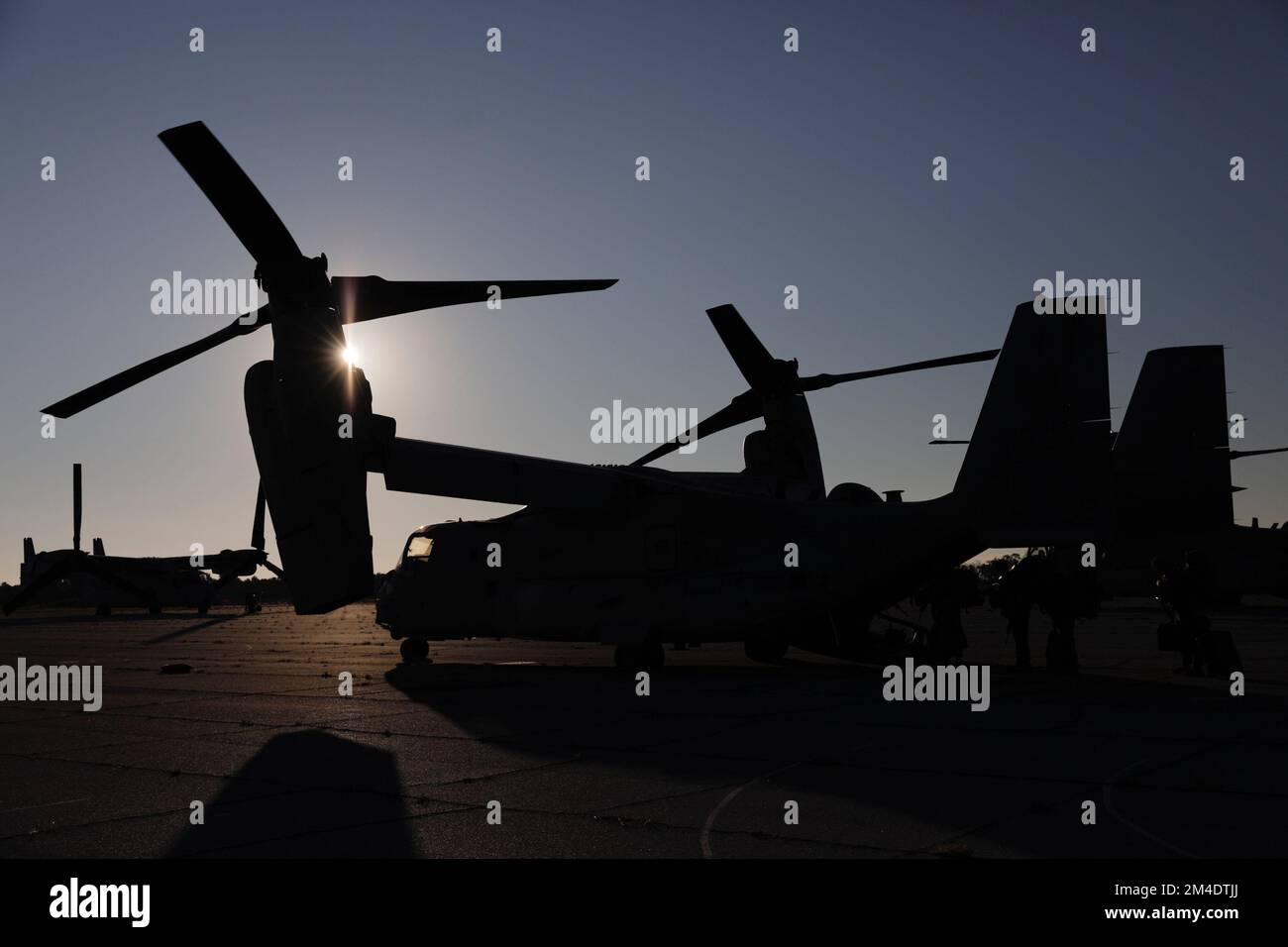 Marines and Sailors with the 26th Marine Expeditionary Unit (MEU) Forward Command Element (FCE) prepare to load an MV-22 Osprey at Marine Corps Auxiliary Landing Field Bogue, North Carolina, Dec. 13, 2022. The 26th MEU FCE traveled to a destination in Savannah, Georgia, as part of Marine Expeditionary Unit Exercise (MEUEX) I to simulate the establishment of a forward command. The focus of MEU Exercise I was to plan, brief, and execute several missions using the rapid response planning process in preparation for deployment alongside the Bataan Amphibious Ready Group. Stock Photo