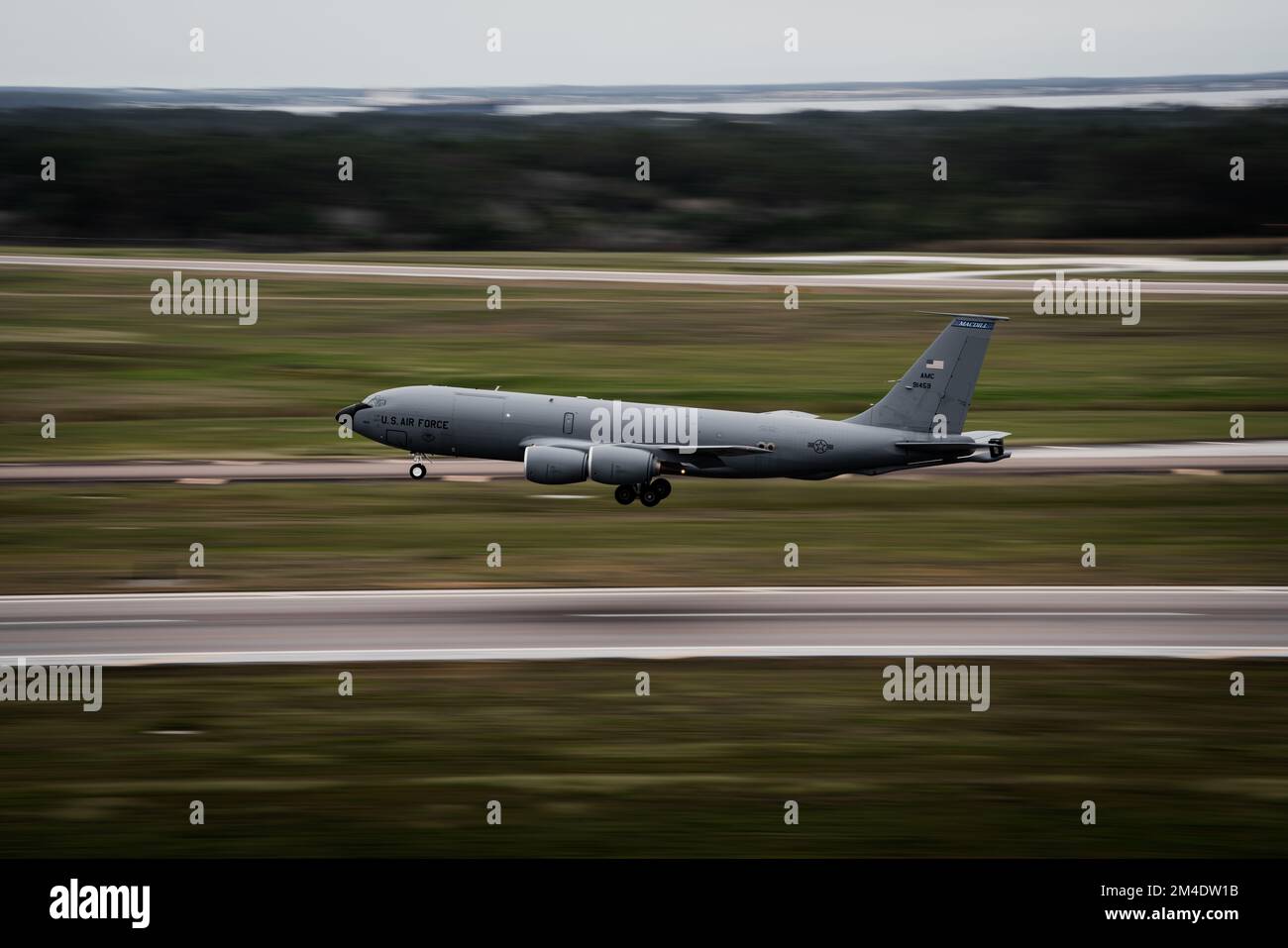 A KC-135 Stratotanker aircraft assigned to the 6th Air Refueling Wing ascends off the runway during a touch-and-go circuit at MacDill Air Force Base, Florida, Dec. 16, 2022. Touch-and-go circuits involve aircraft landing on a runway and taking off again without fully stopping. These exercises provide Air Force pilots opportunities to fine-tune their landing and aviation skills. (U.S. Air Force photo by Senior Airman Joshua Hastings) Stock Photo