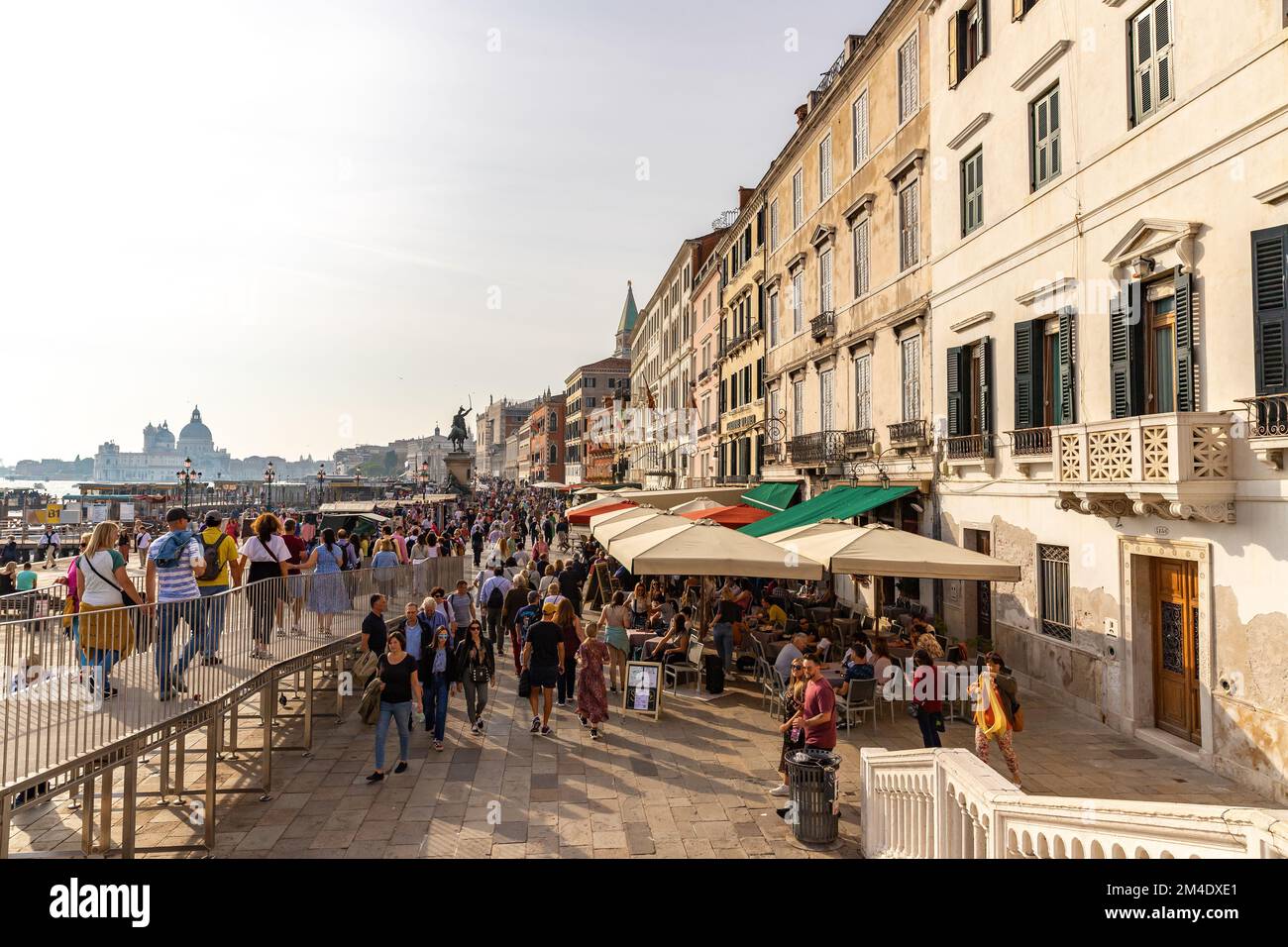 Way from vaporetto stop to San Marco square in Venice, Italy. Tourists on the embankment in Venice. Stock Photo
