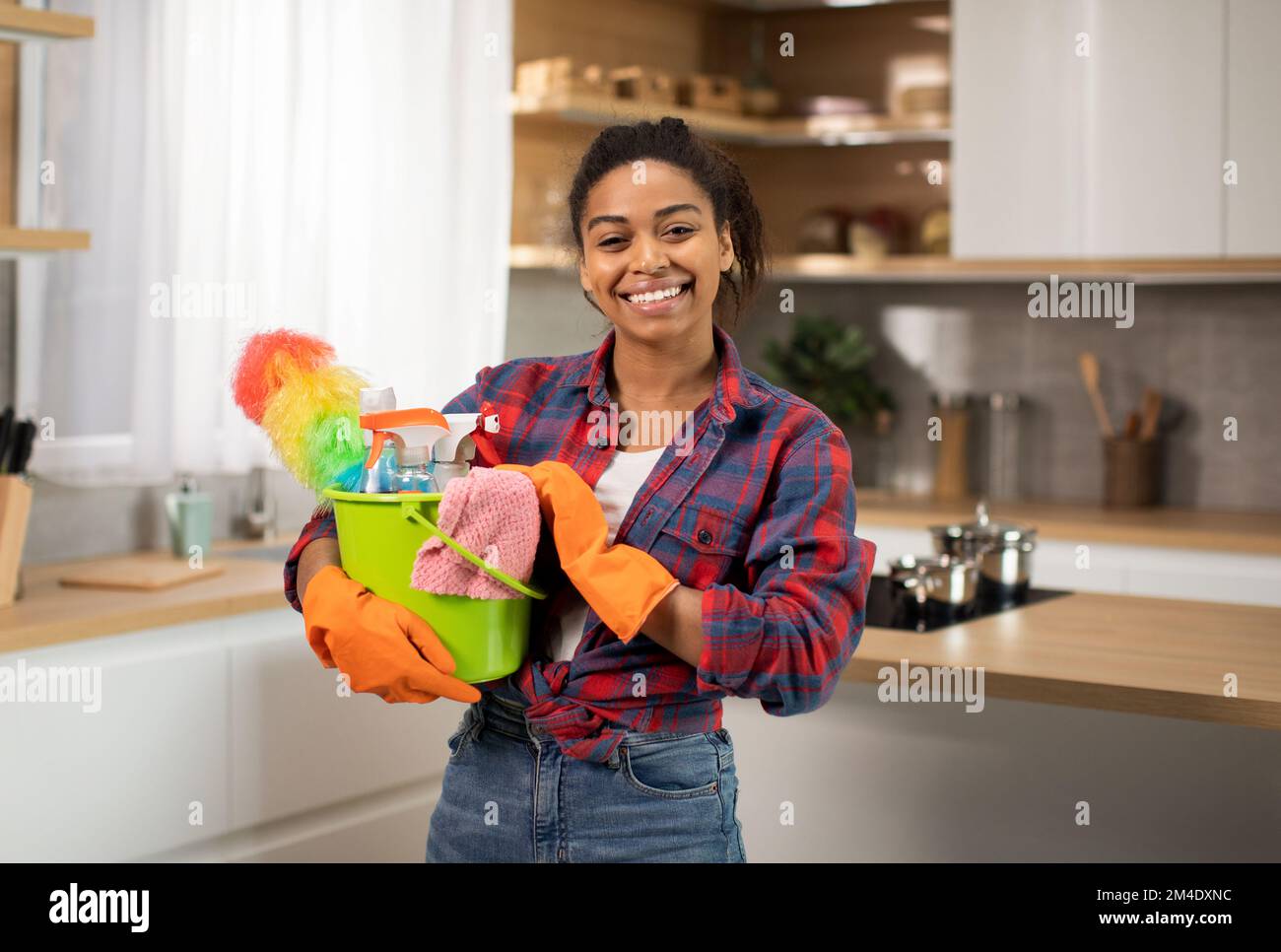 https://c8.alamy.com/comp/2M4DXNC/cheerful-millennial-african-american-female-in-rubber-gloves-with-cleaning-supplies-bucket-enjoys-household-chores-2M4DXNC.jpg