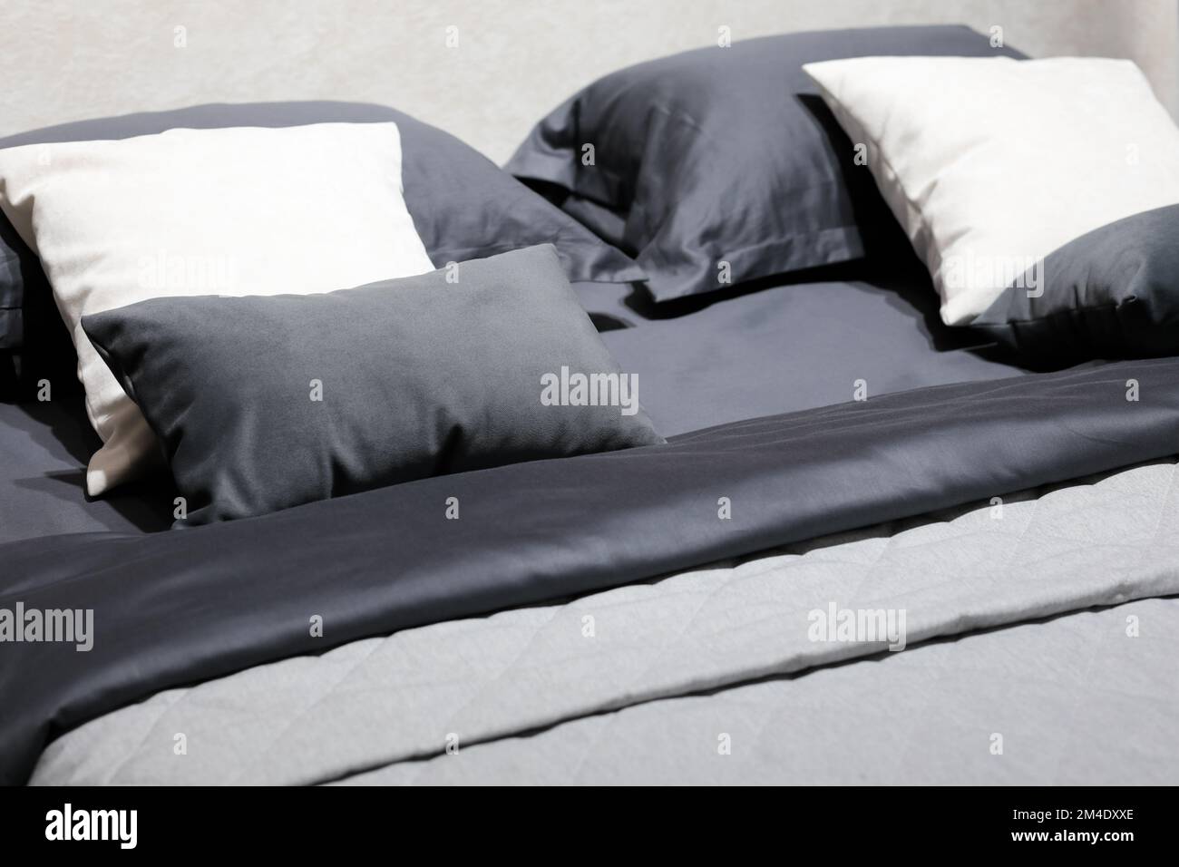 Double bed with pillows, cushions and blankets. Selective focus. Stock Photo