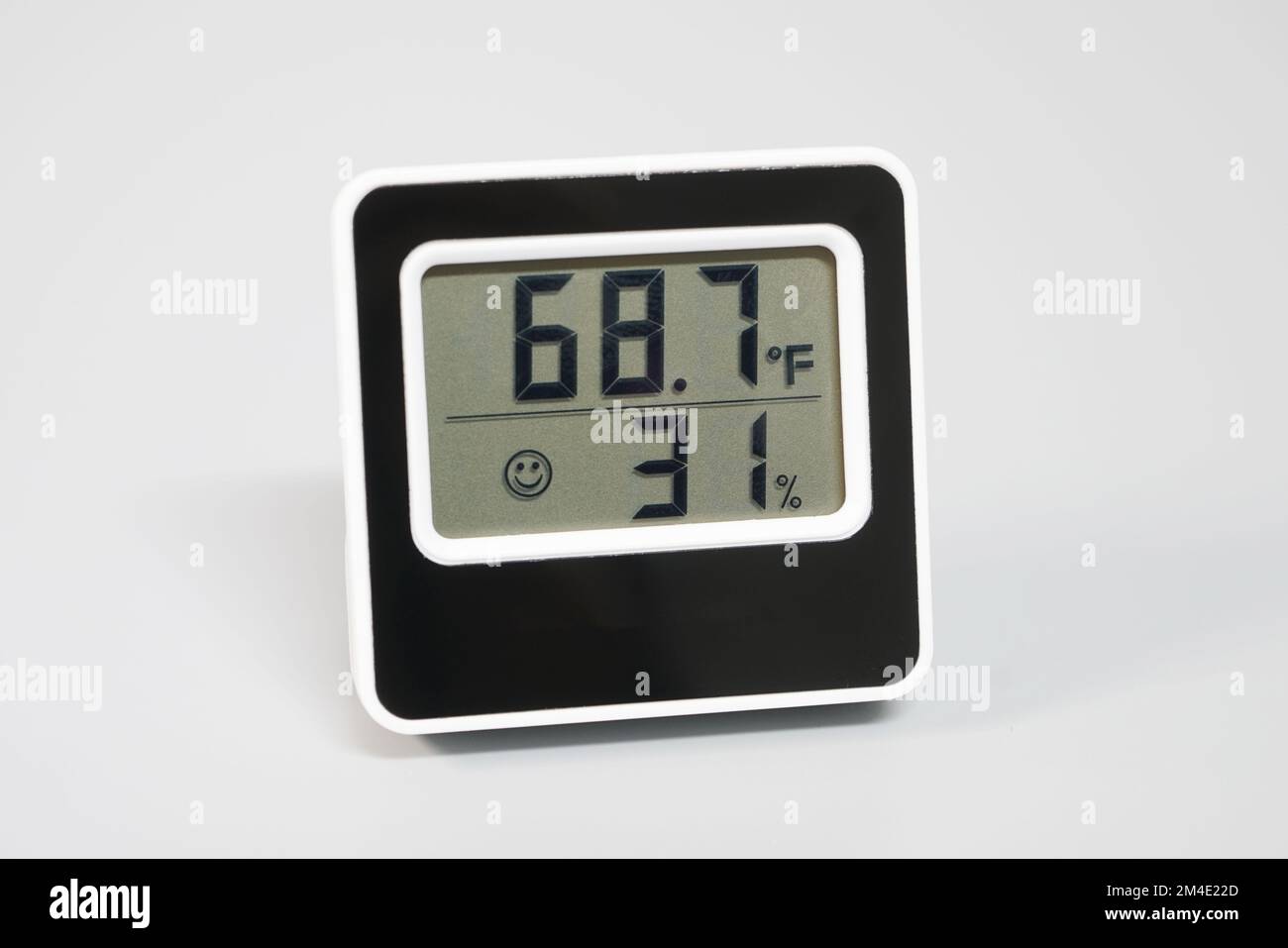 Small digital thermometer and hygrometer for measuring termperature and humidity. Stock Photo