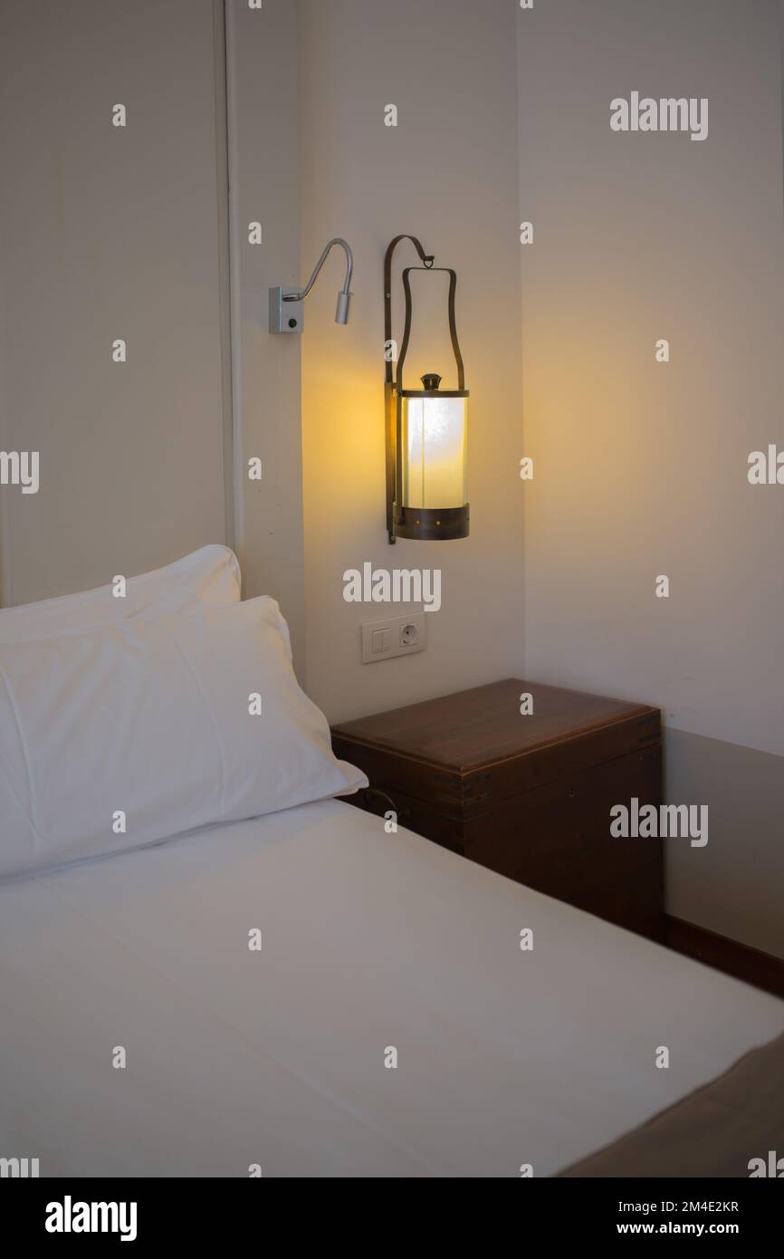 Confortable bed with white linens. Interior Stock Photo
