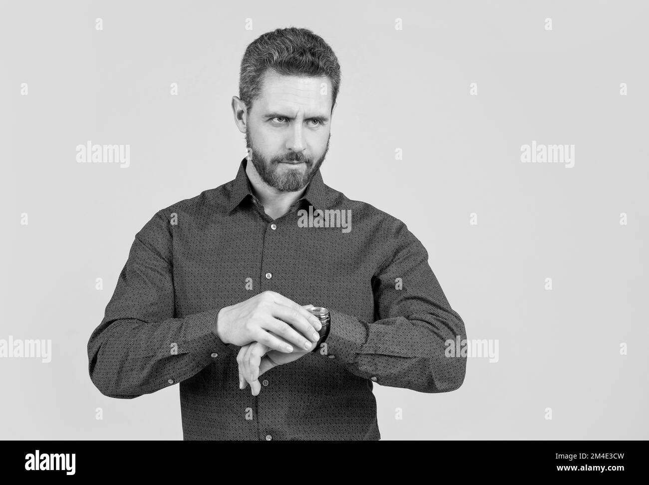 Checking his watch. Bearded man look at wristwatch. Time checking. Deadline date. Being punctual Stock Photo