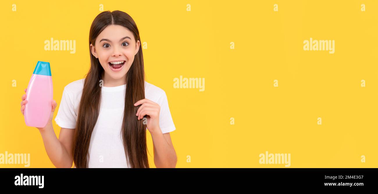 kid use shower gel. shampooing long hair in salon. child with