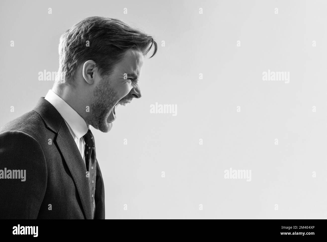 Yelling and screaming. Angry man yell grey background. Manager scream in anger. Yelling guy profile Stock Photo
