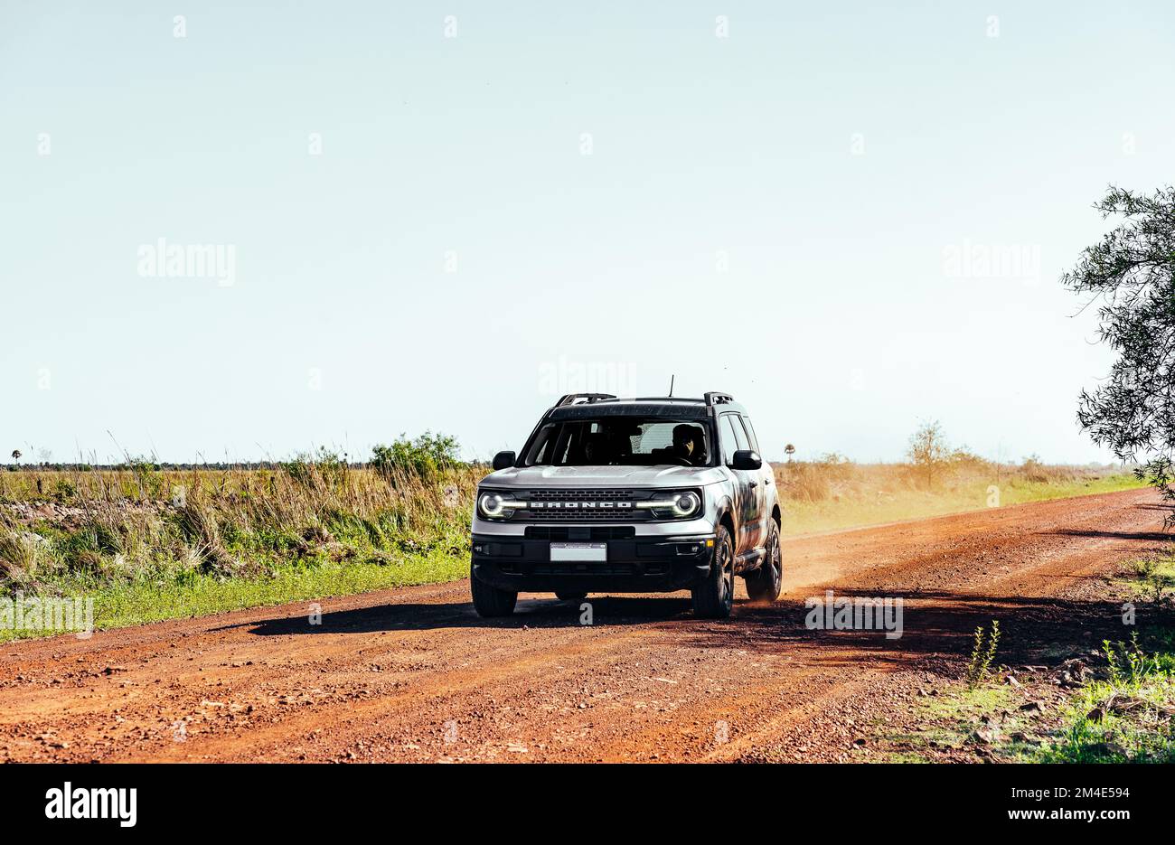 COLONIA CARLOS PELLEGRINI, CORRIENTES, ARGENTINA - NOVEMBER 19, 2021: SUV car drives in the gravel road that join the city of Mercedes and the small t Stock Photo