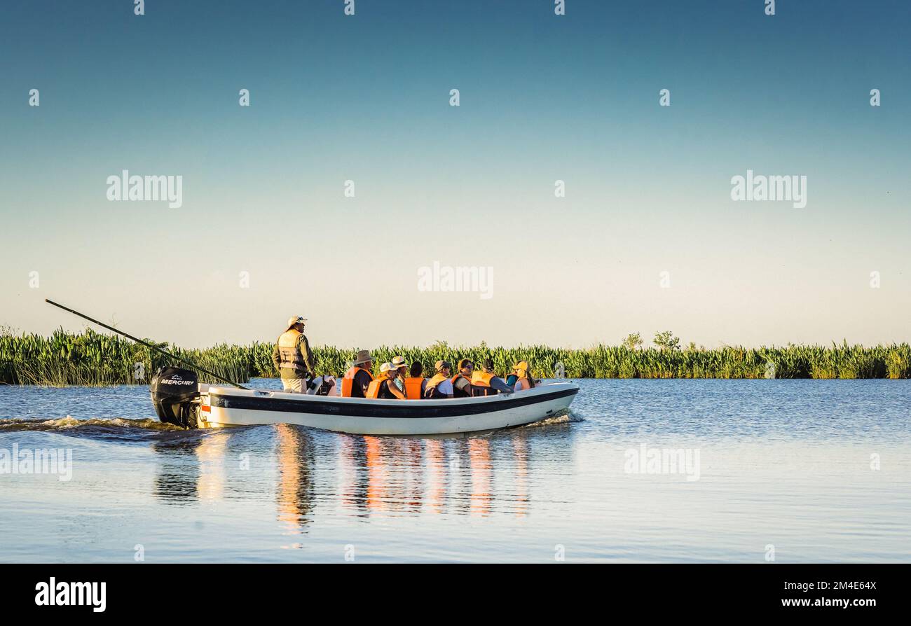 COLONIA CARLOS PELLEGRINI, CORRIENTES, ARGENTINA - NOVEMBER 19, 2021: A speed boat with tourists crossing the Ibera Lagoon, Ibera Wetlands, Argentina Stock Photo