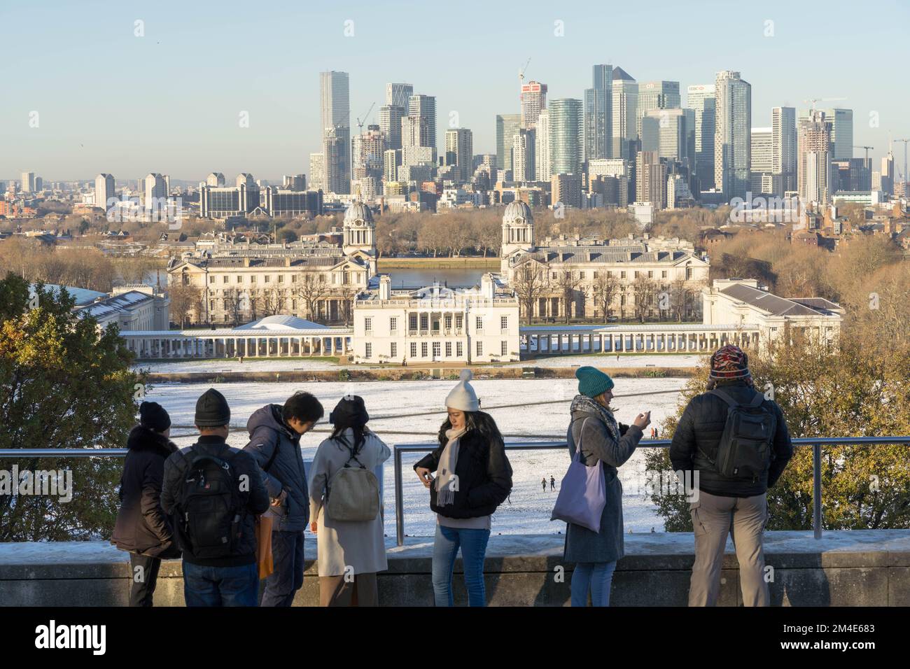General public enjoy some  winter sunshine in deep freeze under arctic snow in Greenwich Southeast London England Stock Photo