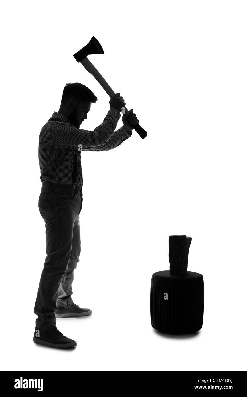 Silhouette of young man chopping wood on white background Stock Photo