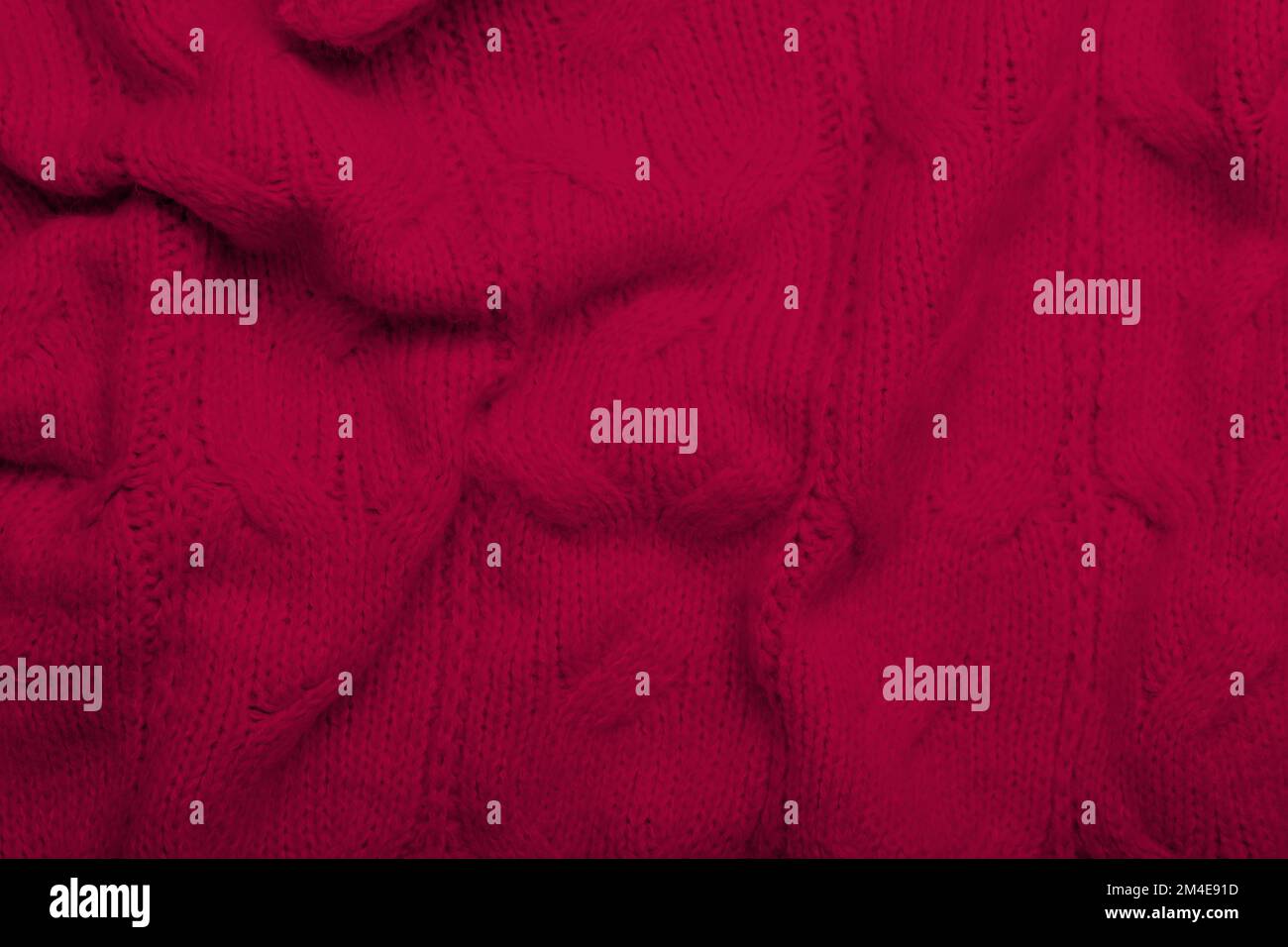 Crumpled knitted viva magenta fabric, closeup Stock Photo
